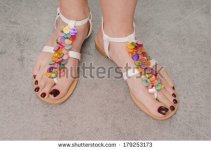 stock-photo--leather-sandals-are-on-female-feet-179253173.jpg