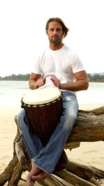 josh_holloway_drum_beach_sand_barefoot_with_long_blond_hair.jpg