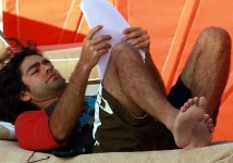 Adrian Grenier reading at the beach.jpg