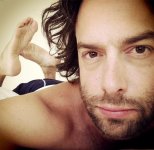 Chris D'Elia legs behind head.jpg