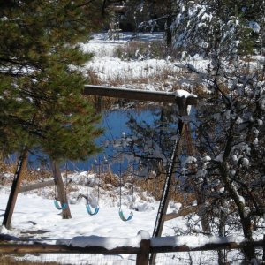 Snow covered swing set.