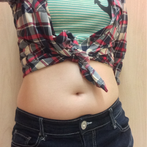 My tummy in a crop top and flannel