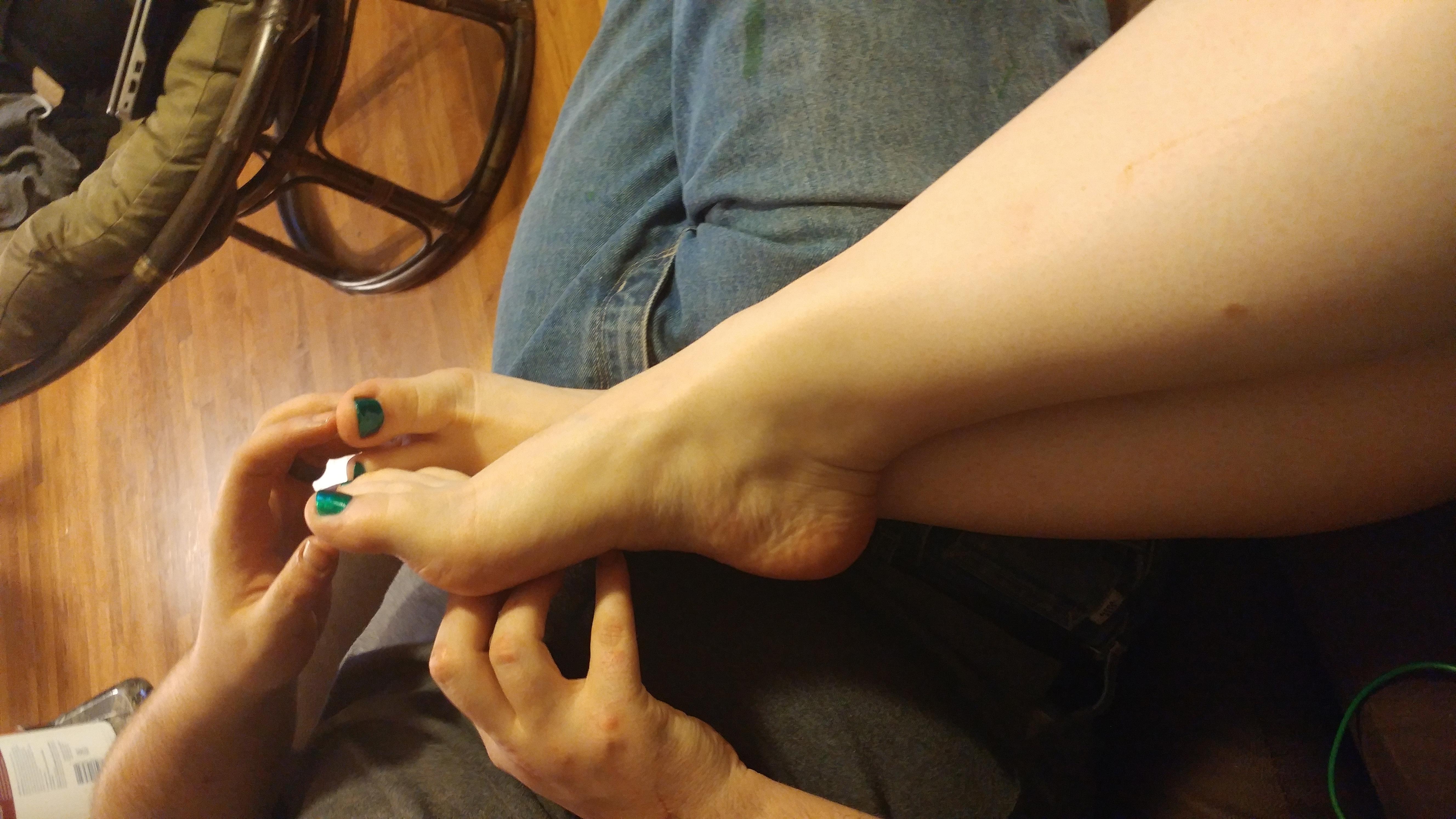 Feet in husband's lap.