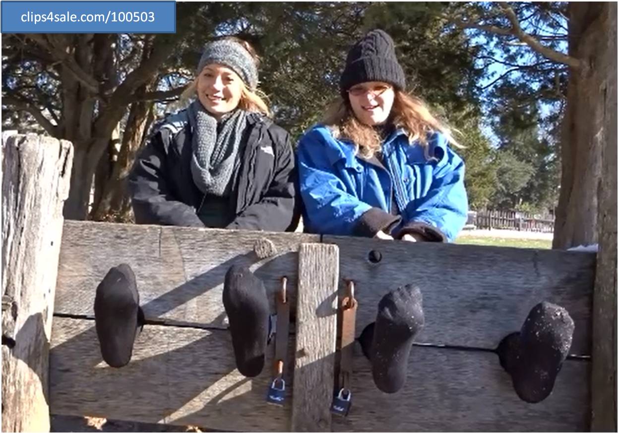 Locked in the stocks in black tights