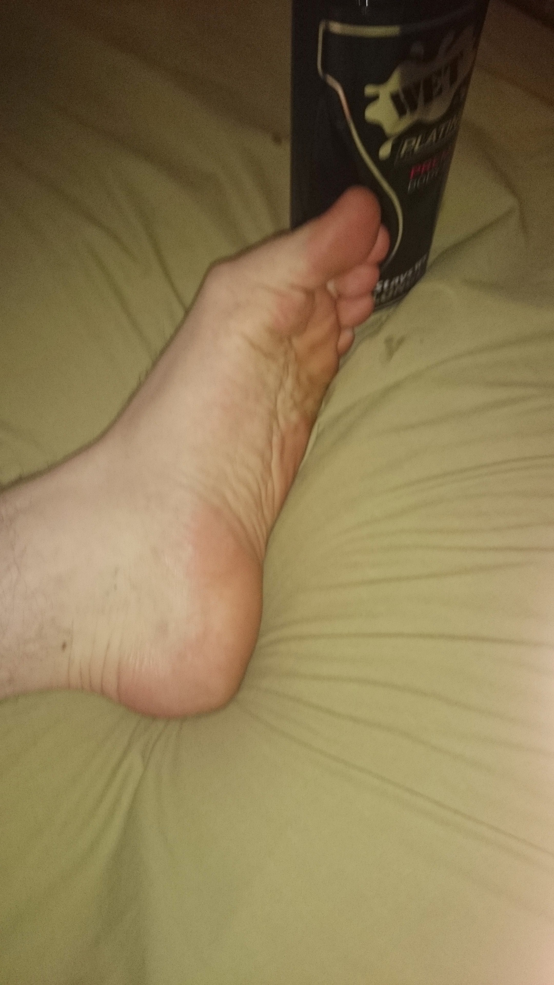 My feet beside my Mistress's favorite tickling tool.