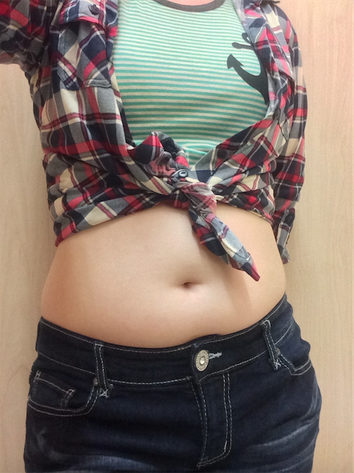 My tummy in a crop top and flannel