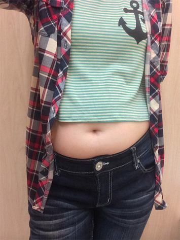 My tummy in a crop top and flannel