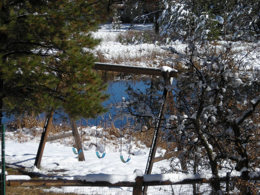 Snow covered swing set.