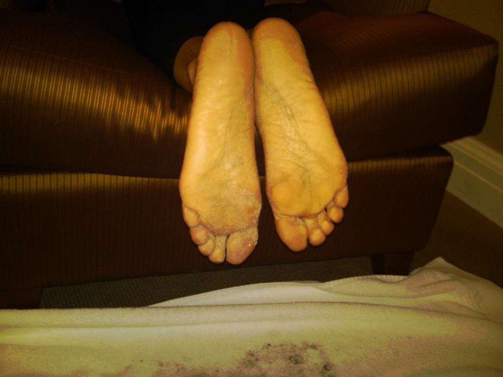 With sandy bare soles.